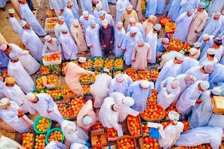 Aerial view of bustling local market with people and fruit